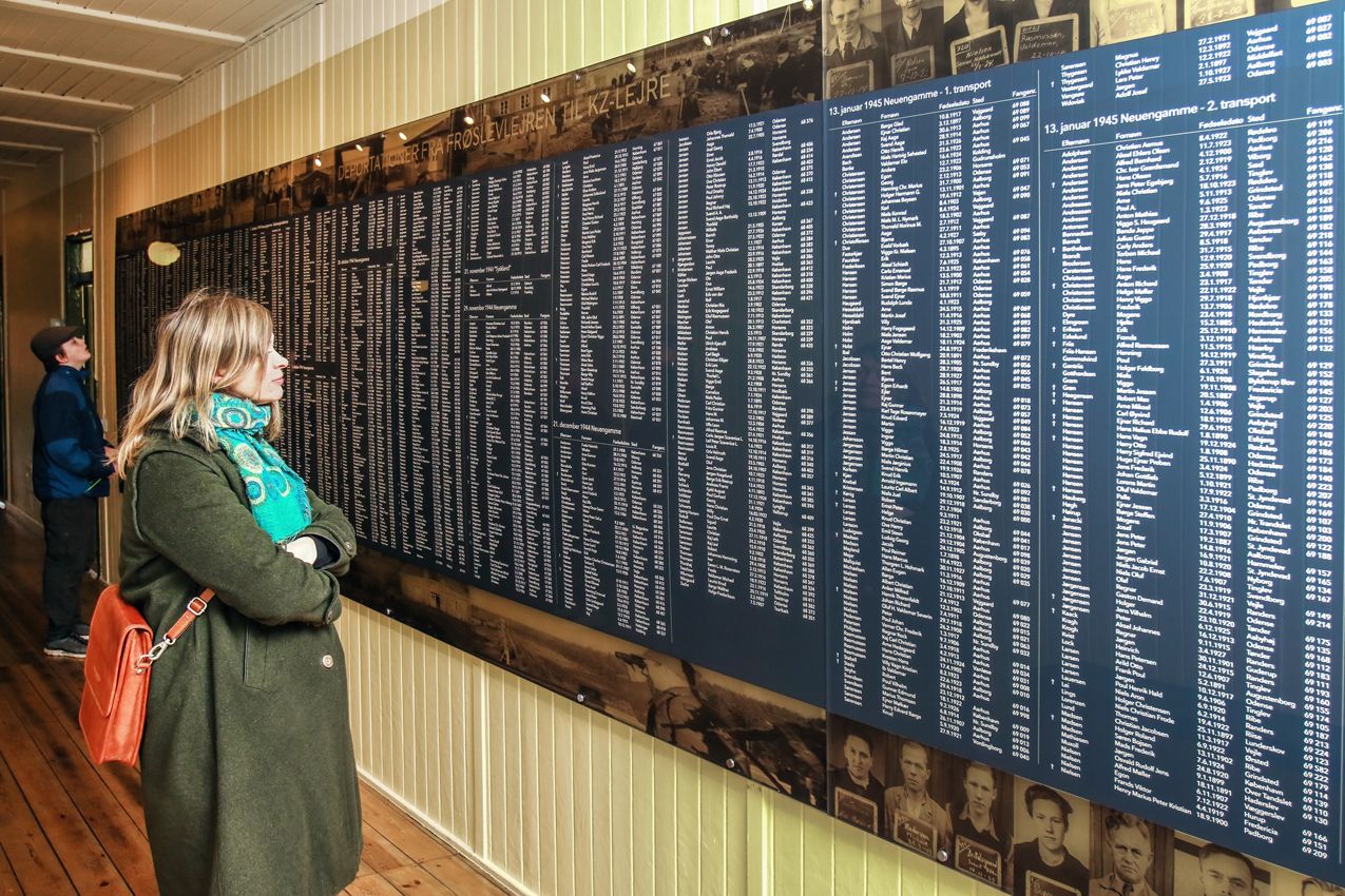 Guest looks at a board with the names of those who were held captive in the Frøslev camp