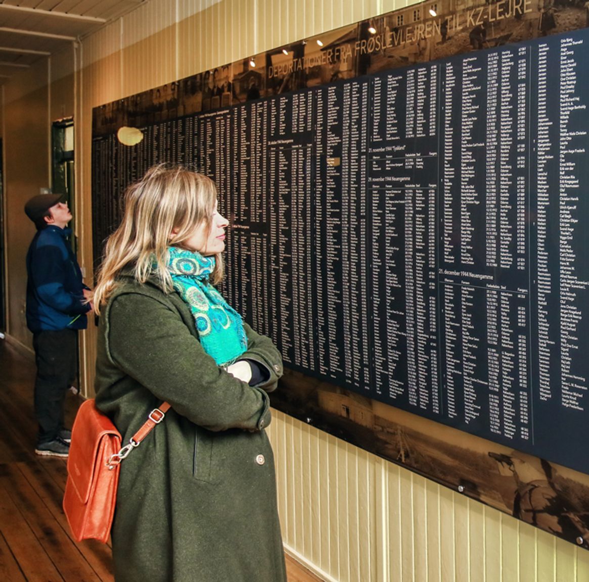 Guest looks at a board with the names of those who were held captive in the Frøslev camp