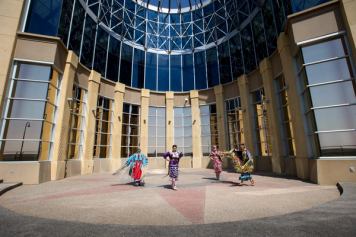 Siksika Blackfoot dancers in front of the Blackfoot Crossing Historical Park Interpretive Centre