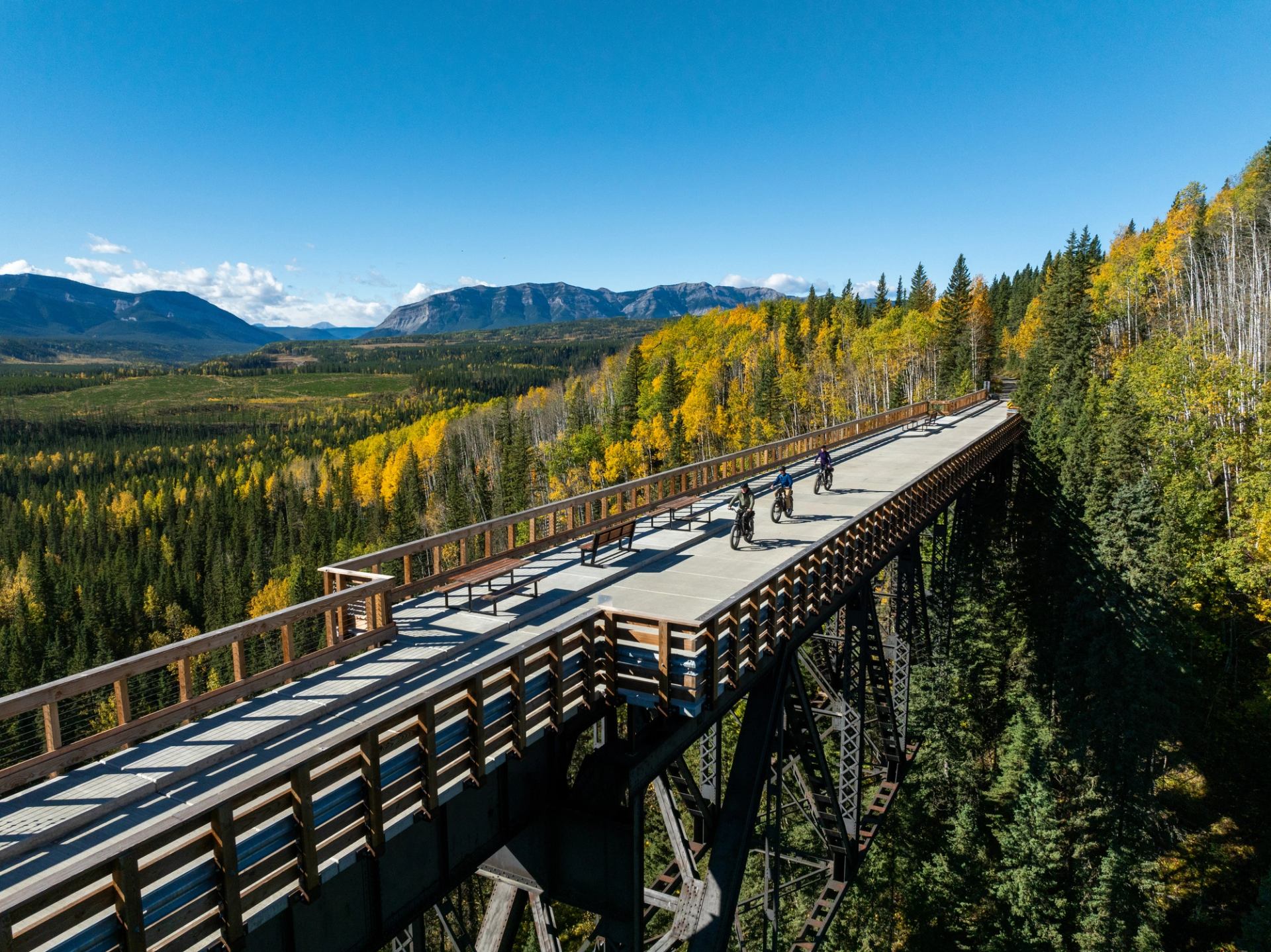Aerial shot of three bikers on bridge in the Nordegg Area backcountry.