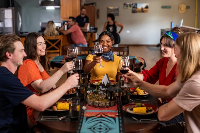 Friends enjoy dinner around a table together.