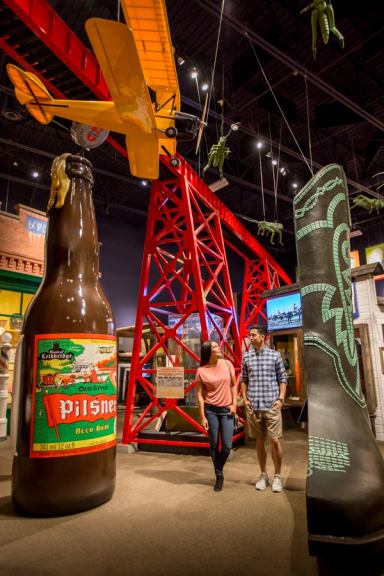 Two visitors explore an exhibit on local industry at the Galt Museum.