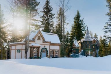 Two storybook-inspired cottages are covered in snow at Charmed Resorts in Alberta.