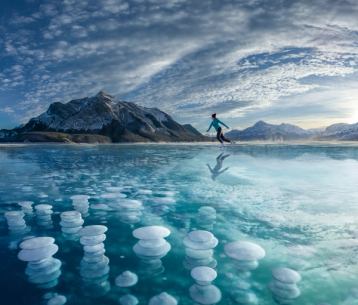 Picture of a person skating on a frozen lake