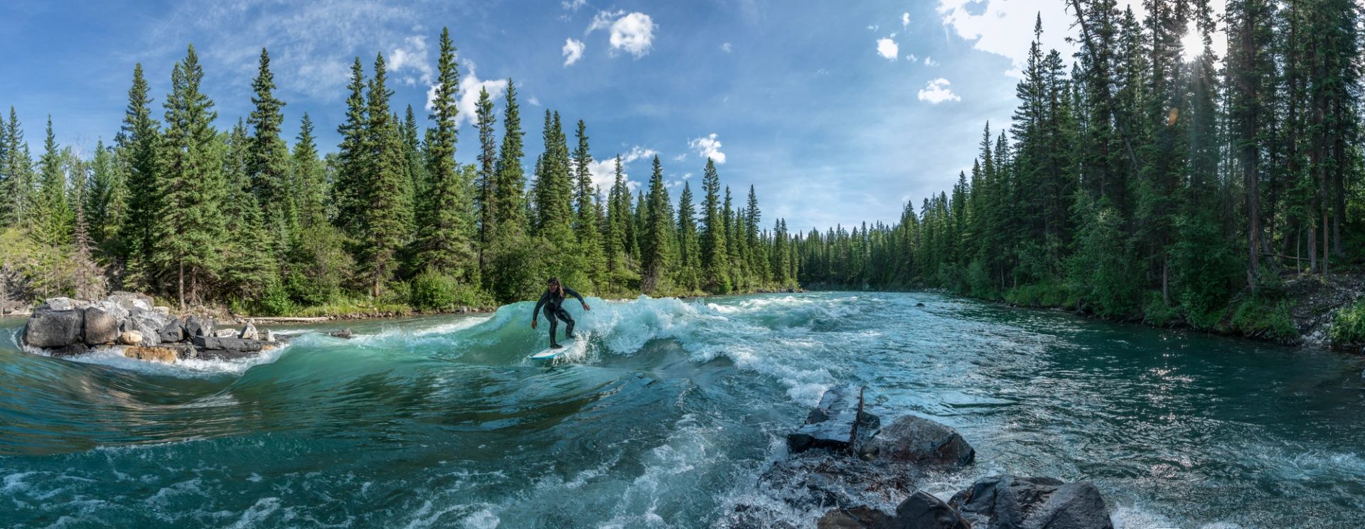 A person river surfing in Kananaskis Country