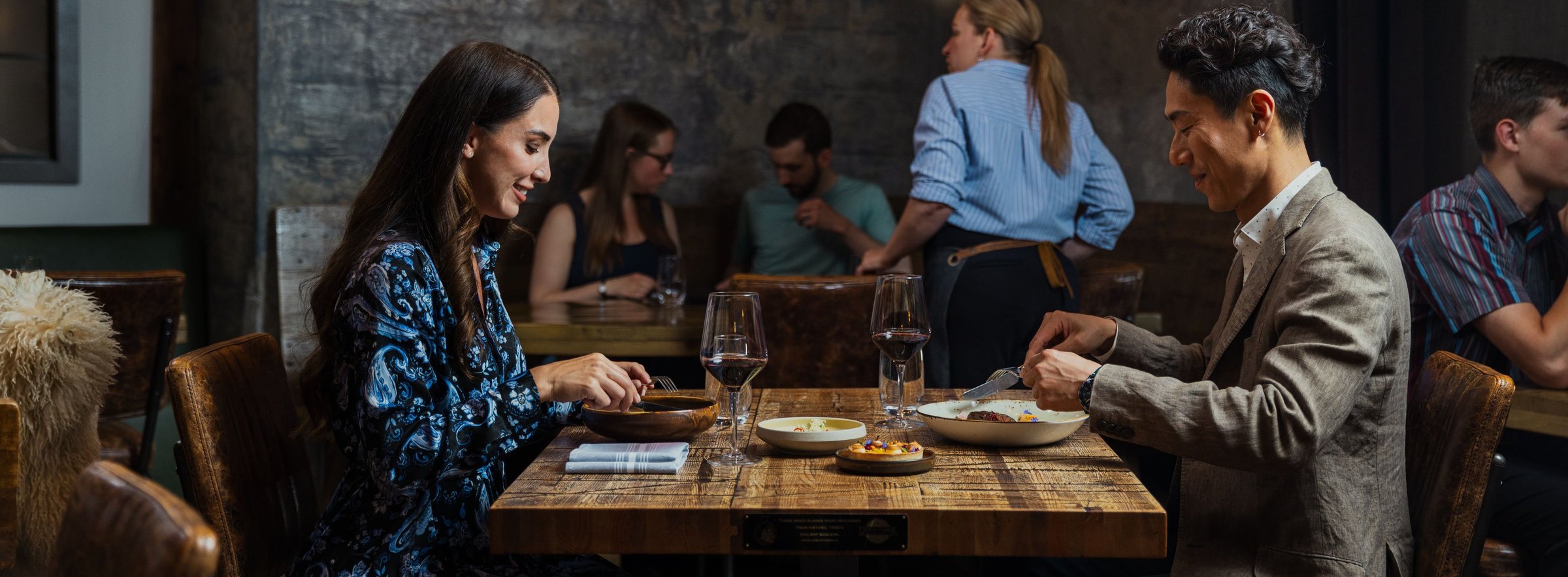 Two people eat dinner at a restaurant