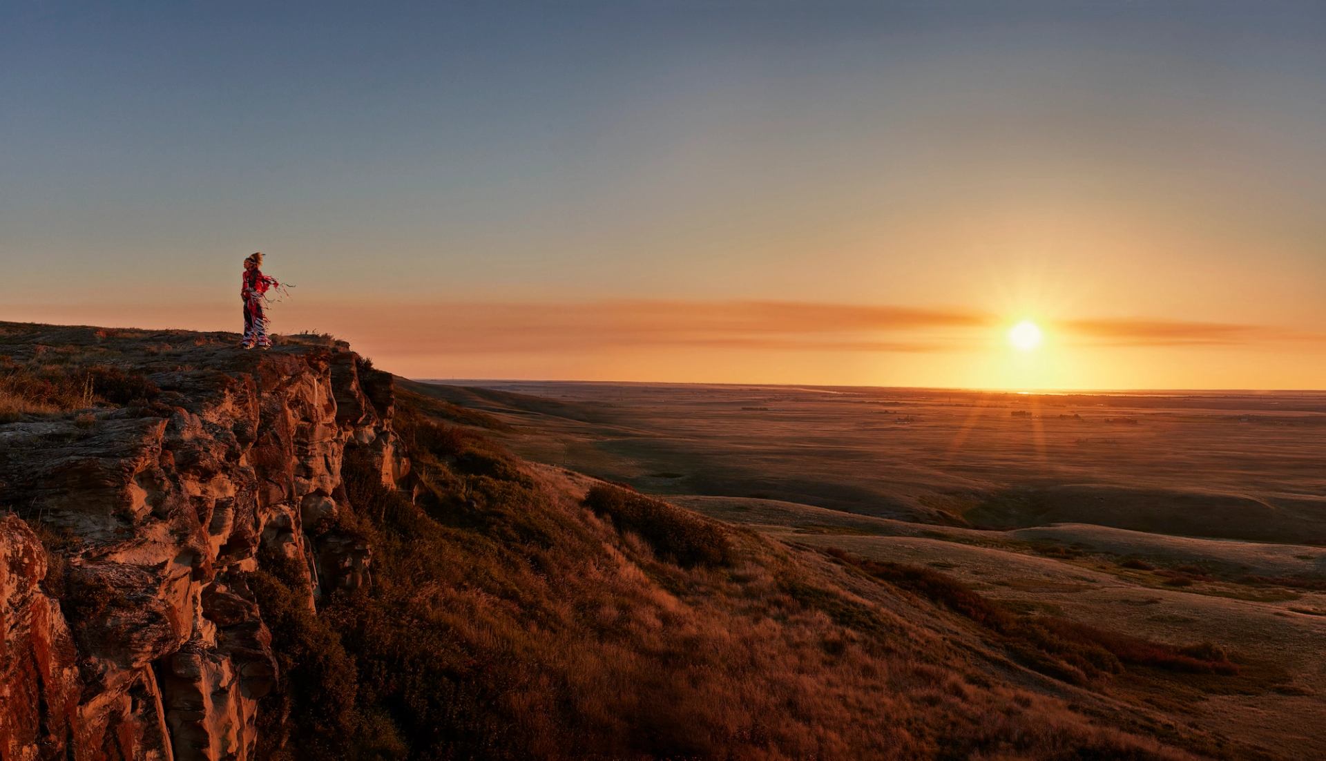 Indigenous man in the Head-Smashed-In Buffalo Jump landscape.