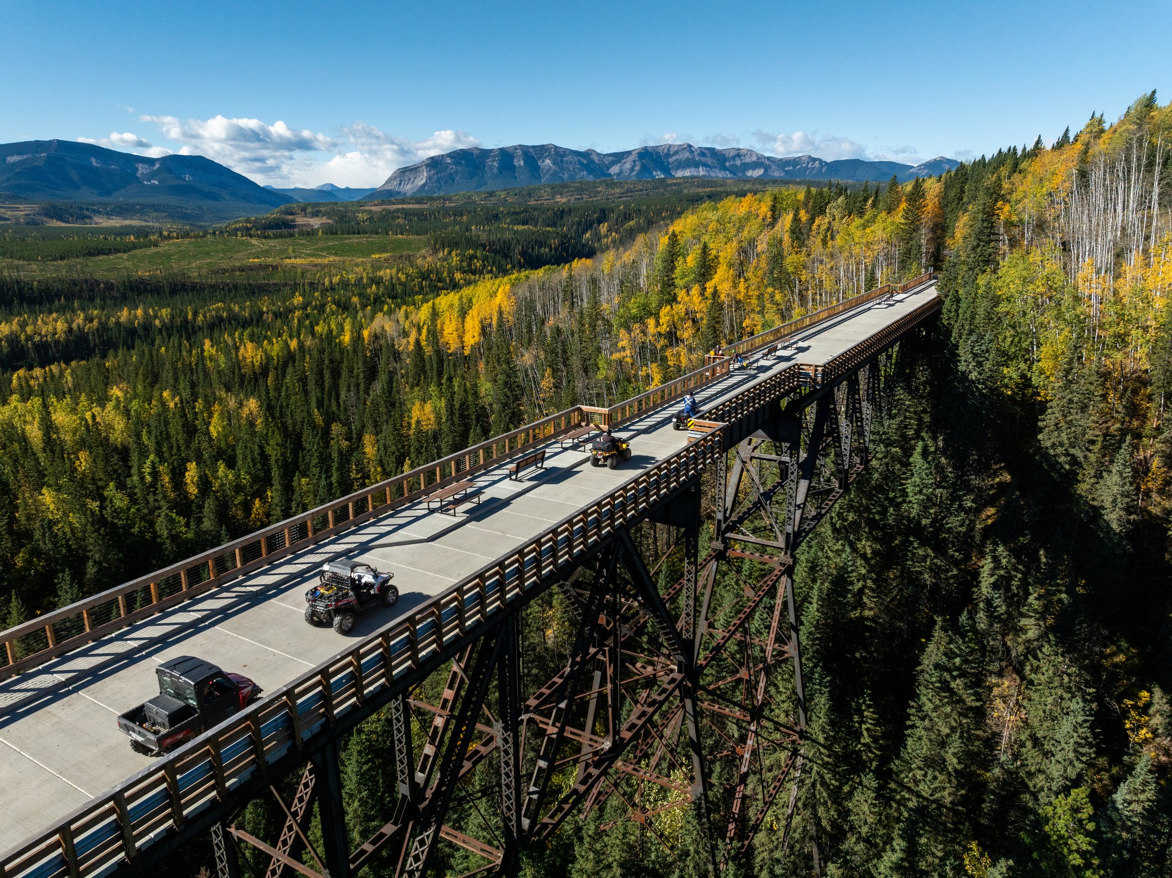 Aerial Shot of ATVs crossing a bridge
