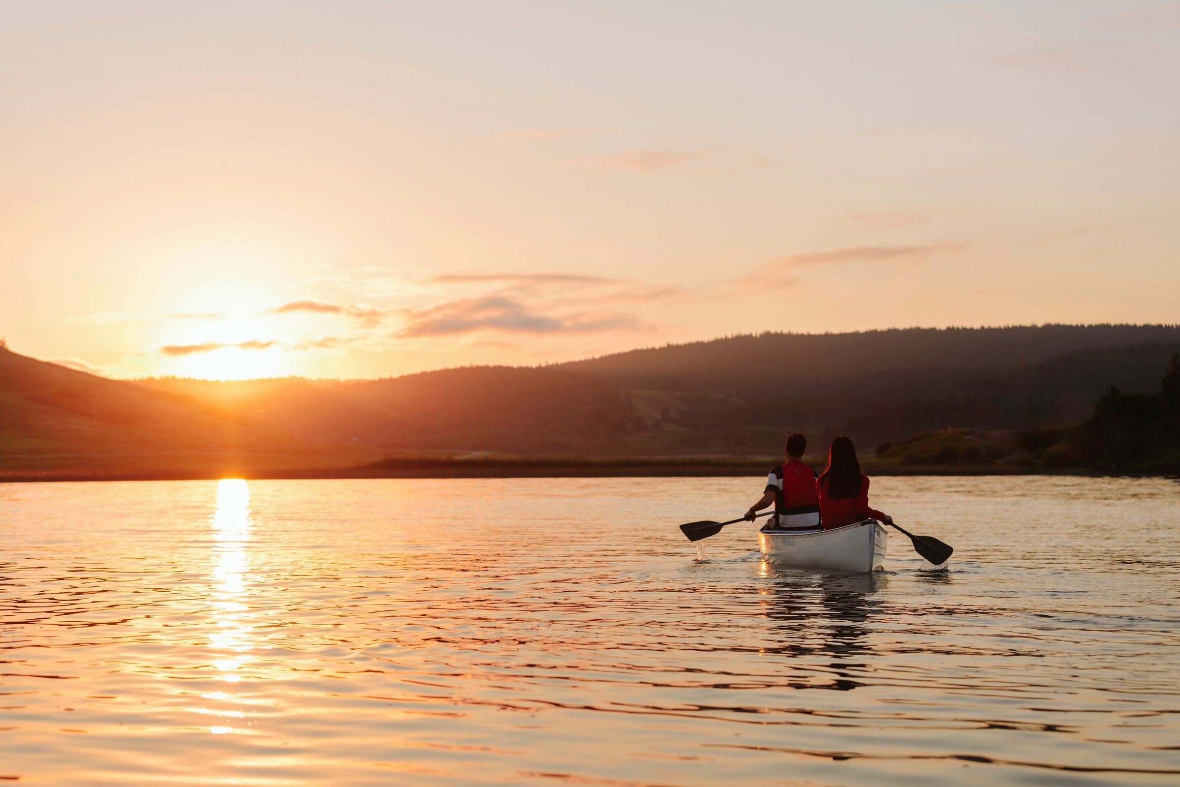 couple canoeing cypress lake sunrise