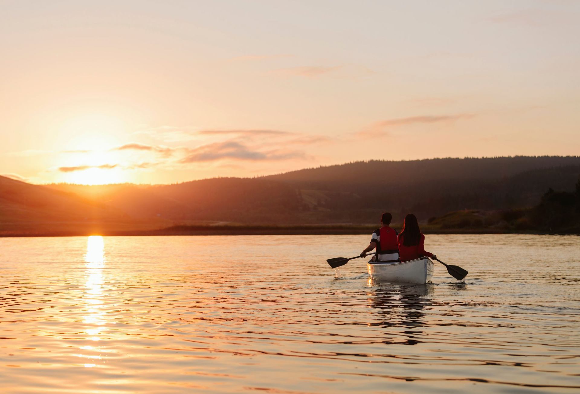 couple canoeing cypress lake sunrise