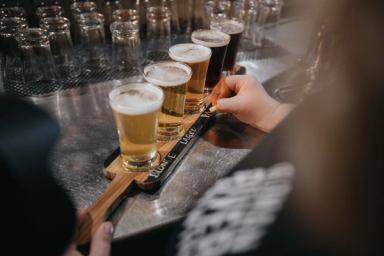 A server labels a flight of beers. 