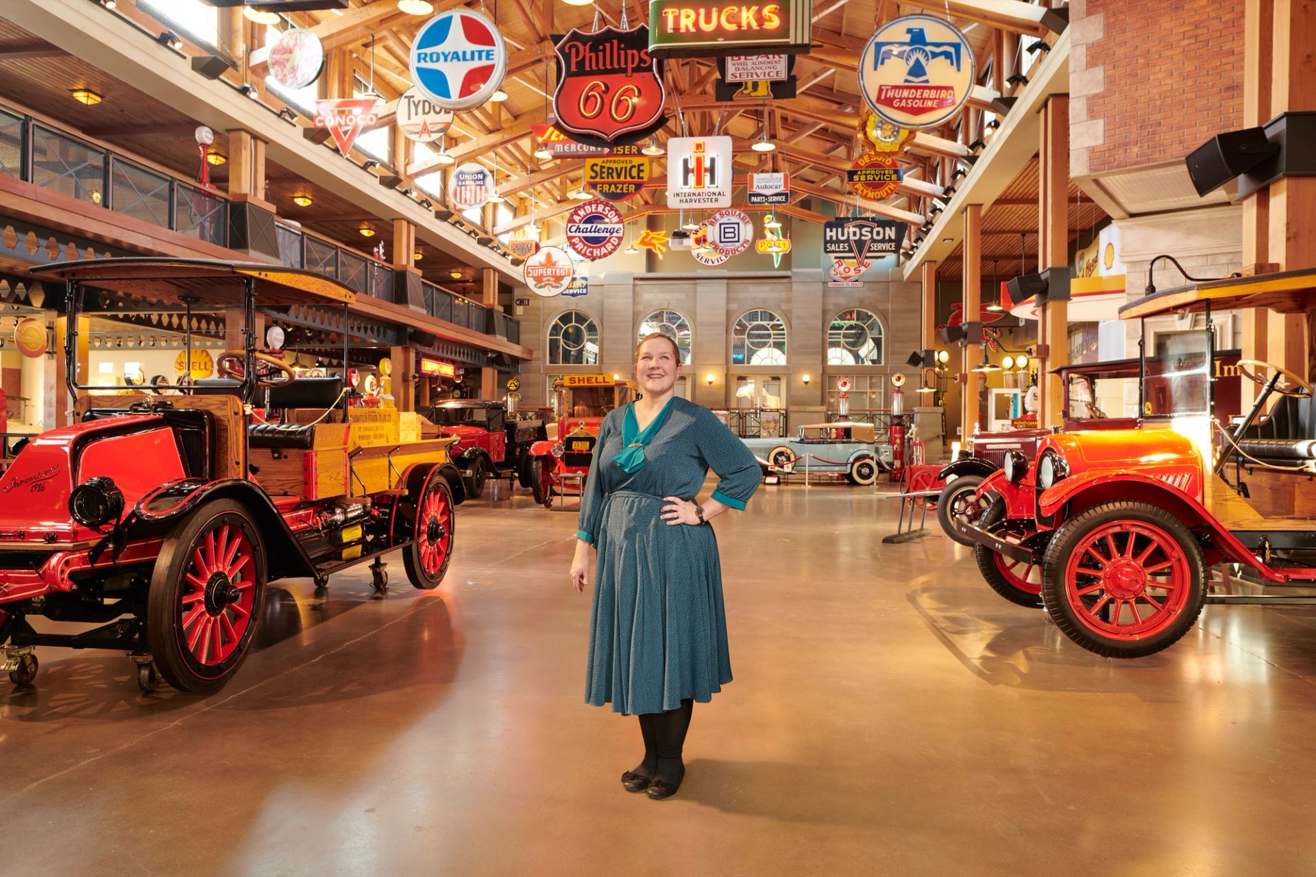 A women poses among the car museum at Heritage Park in Calgary