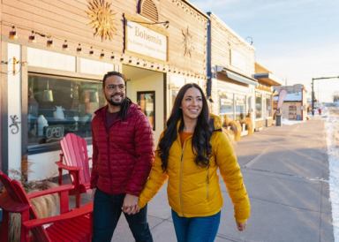 Couple walking hand in hand down street in Diamond Valley