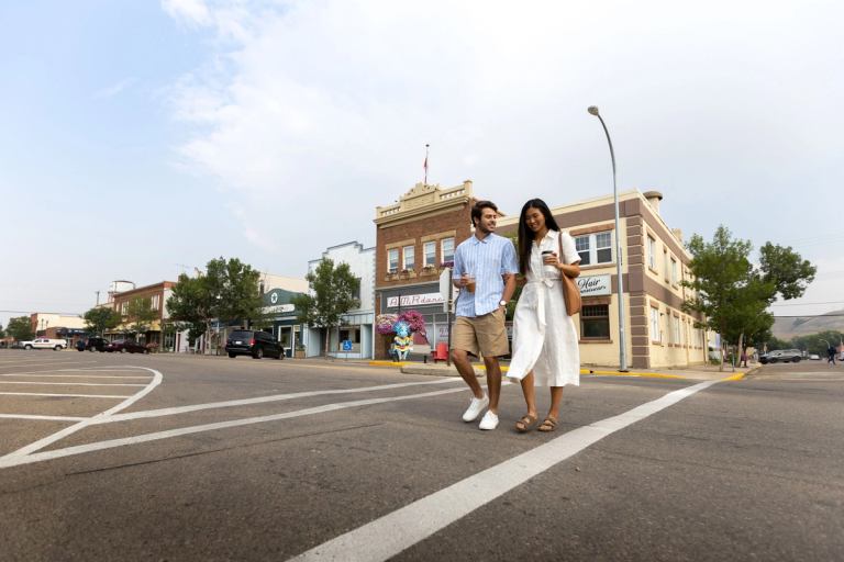 Couple walking across crosswalk in a small town