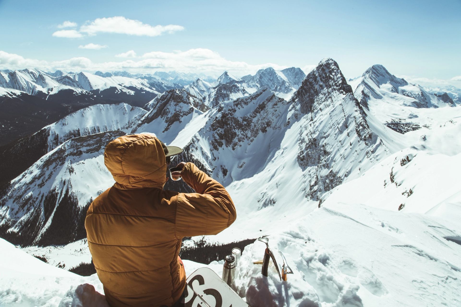 Snowboarder taking a break in the backcountry at Mount Smuts in Kananaskis Country