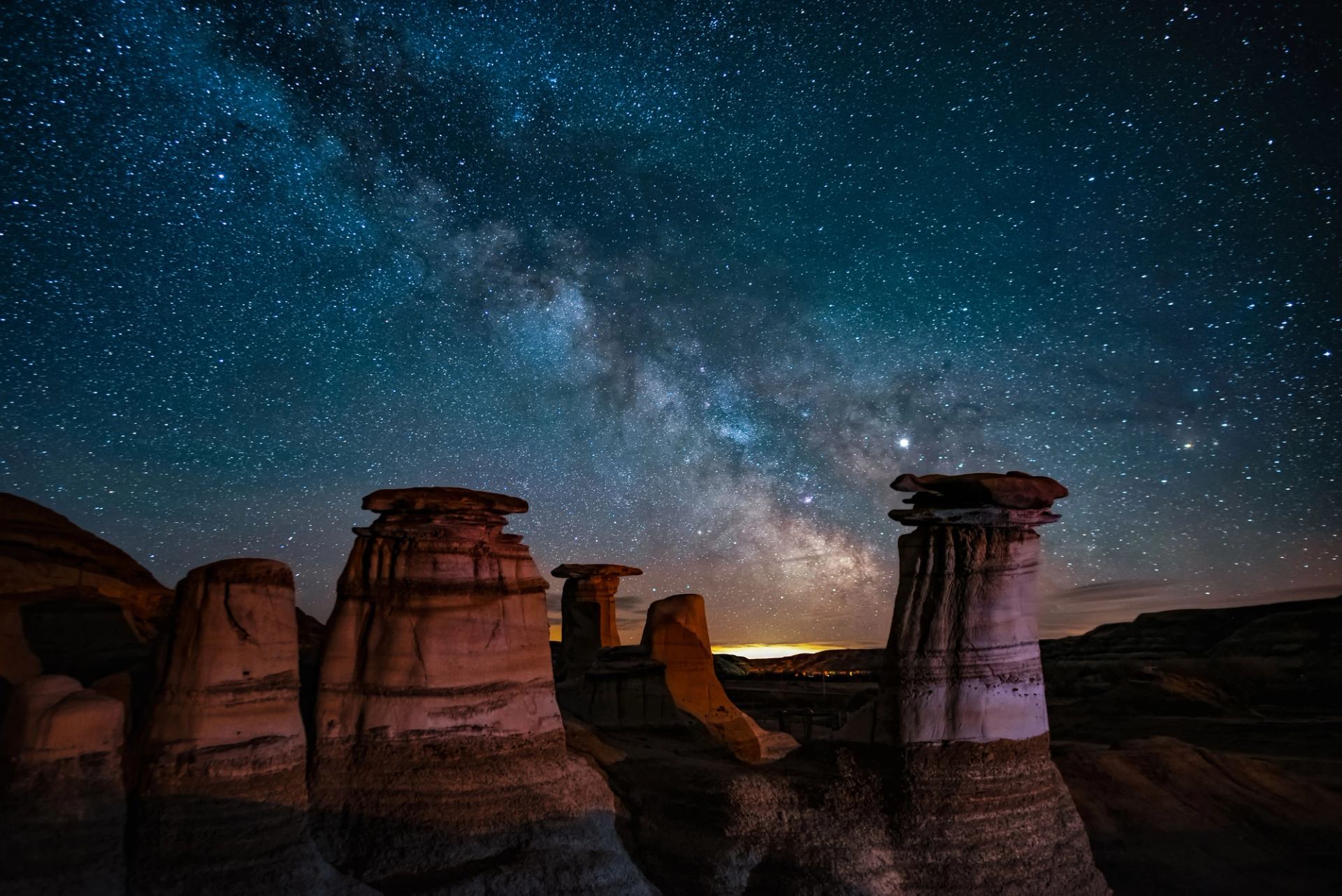 Starry night sky, hoodoos.