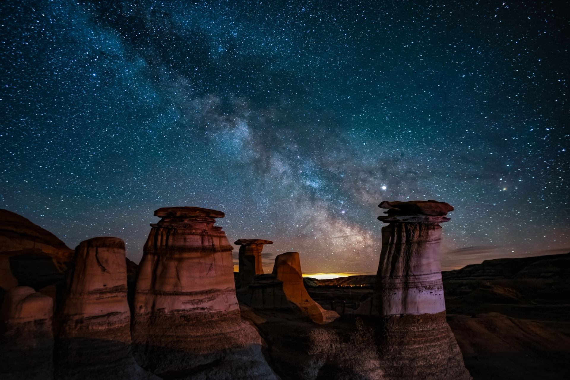 Starry night sky, hoodoos.