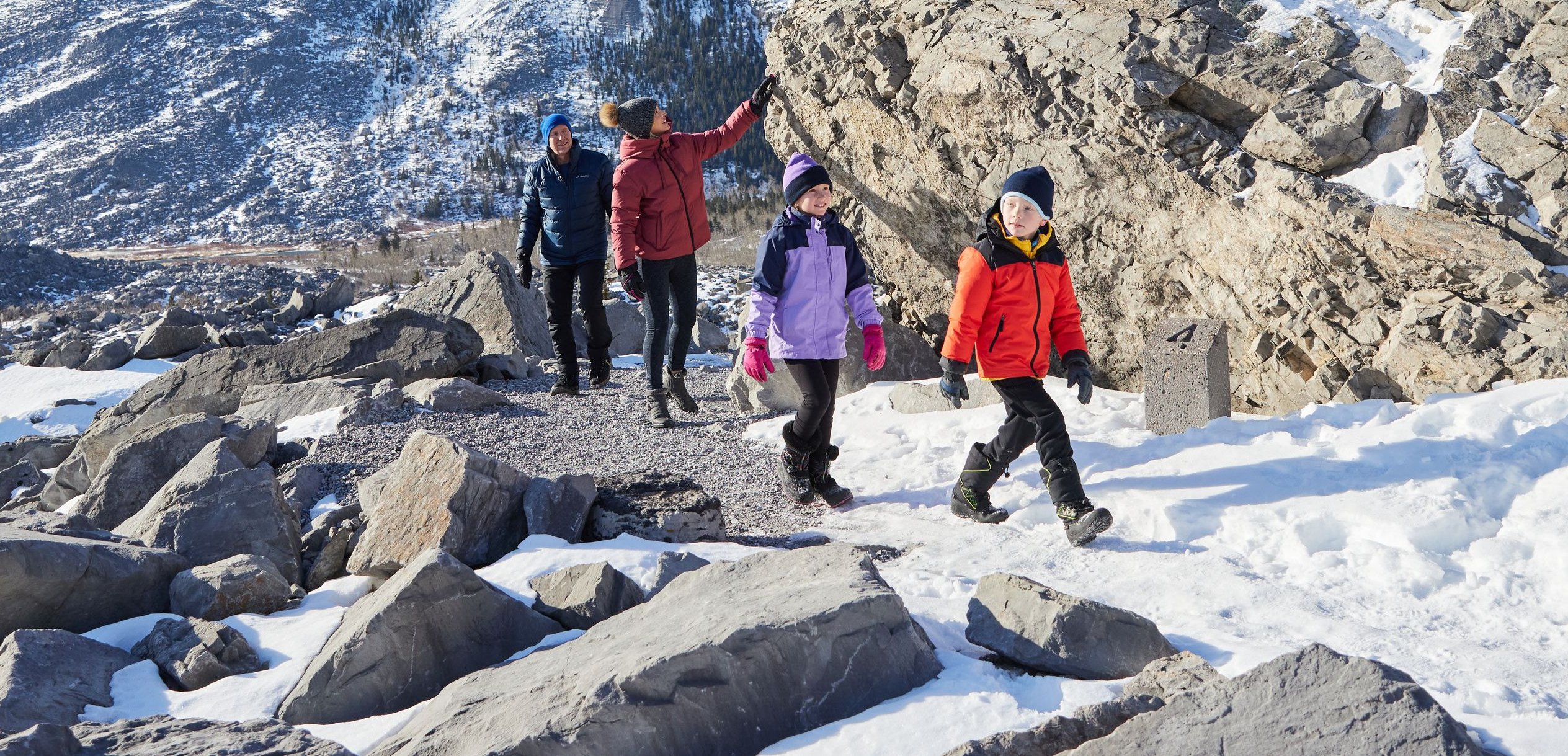 A family hiking and exploring at Frank Slide in the Crowsnest Pass.