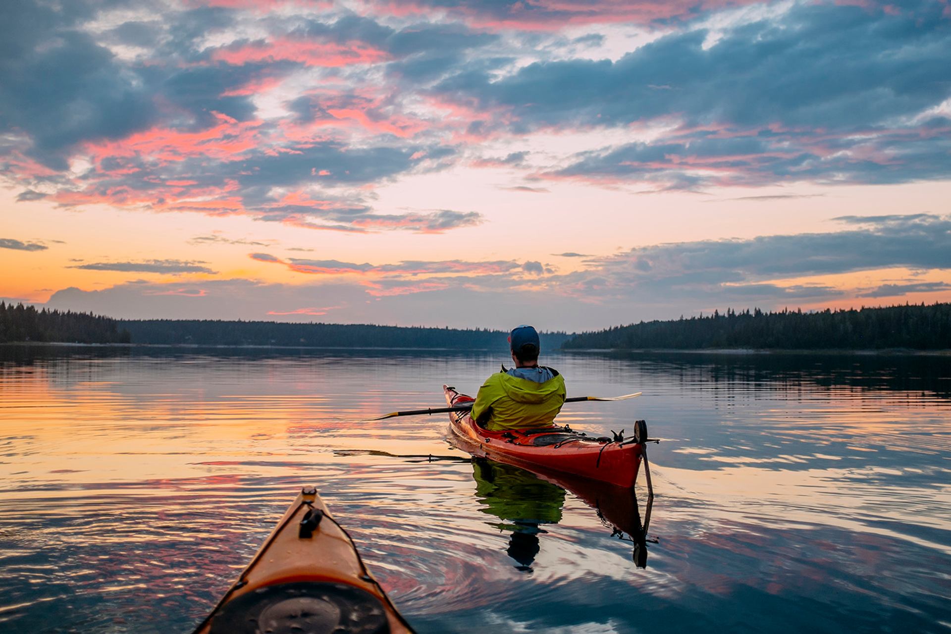 People kayaking on a lake at sunset in Wood Buffalo National Park