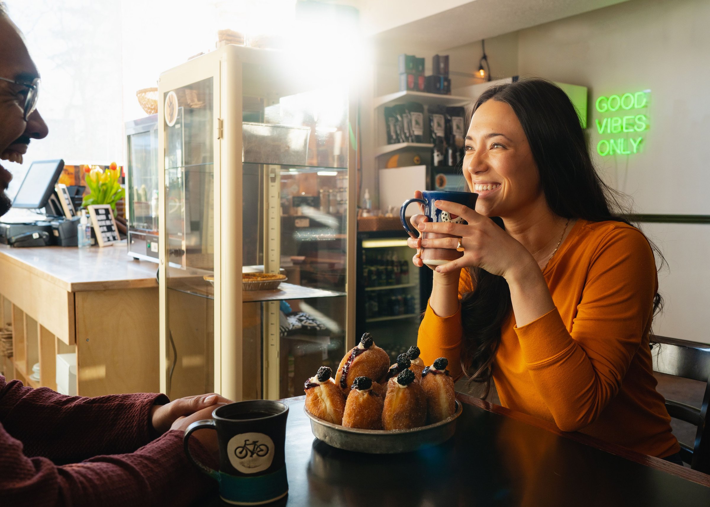Man and woman enjoying hot beverages and pastries at The Westwood in Diamond Valley.