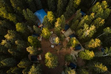 An overhead view of cabins in a forest setting.
