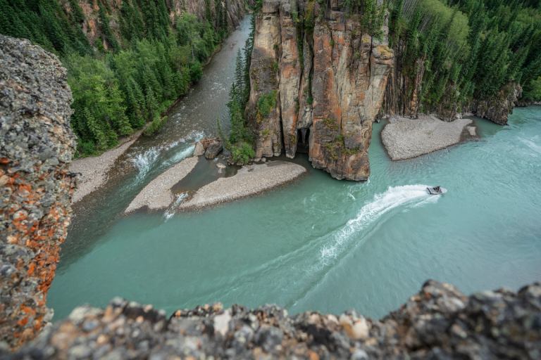 A bird's-eye view of Sulphur Gates in Grande Cache with a speed boat cutting through the blue-green water.