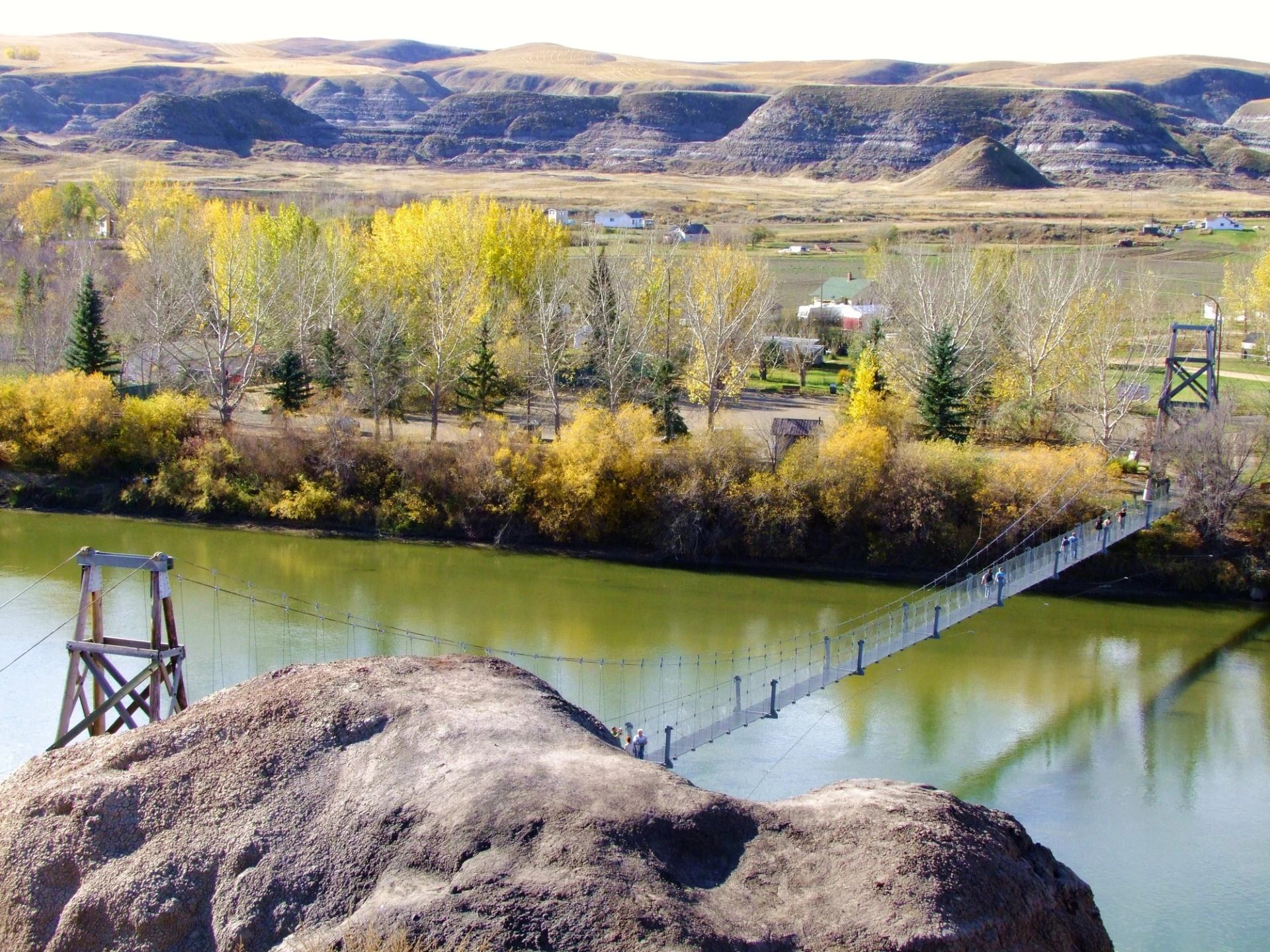 Visitors walking across the Rosedale Suspension Bridge in Drumheller.