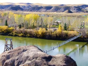 Visitors walking across the Rosedale Suspension Bridge in Drumheller.