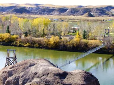 Visitors walking across the Rosedale Suspension Bridge in Drumheller.