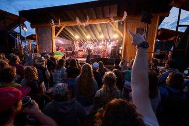 A crowd watches a band at an outdoor stage in Hinton.