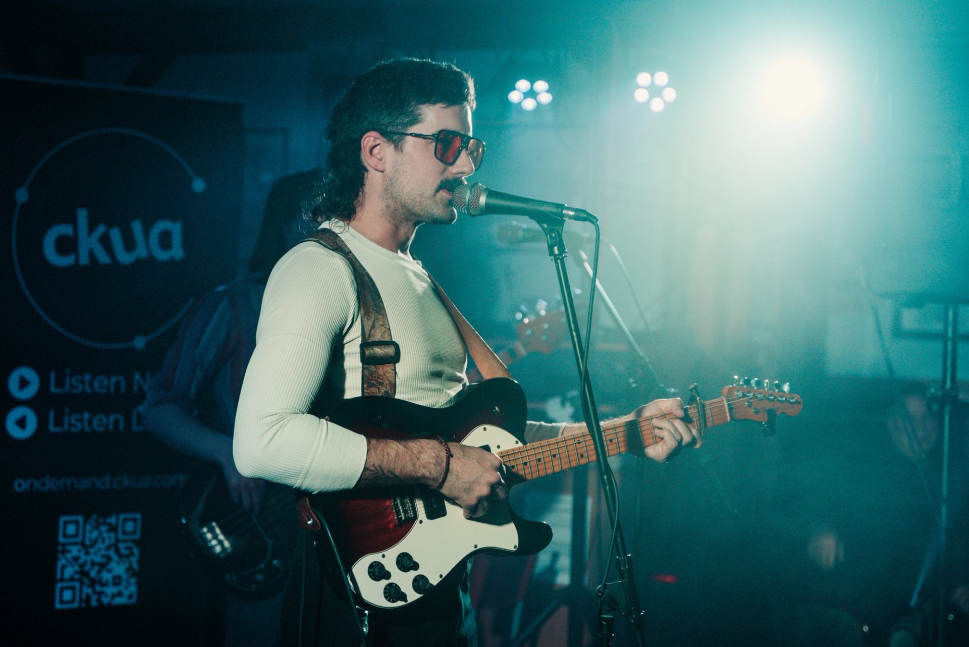 Photo of lead singer with guitar at Cold Bones Festival