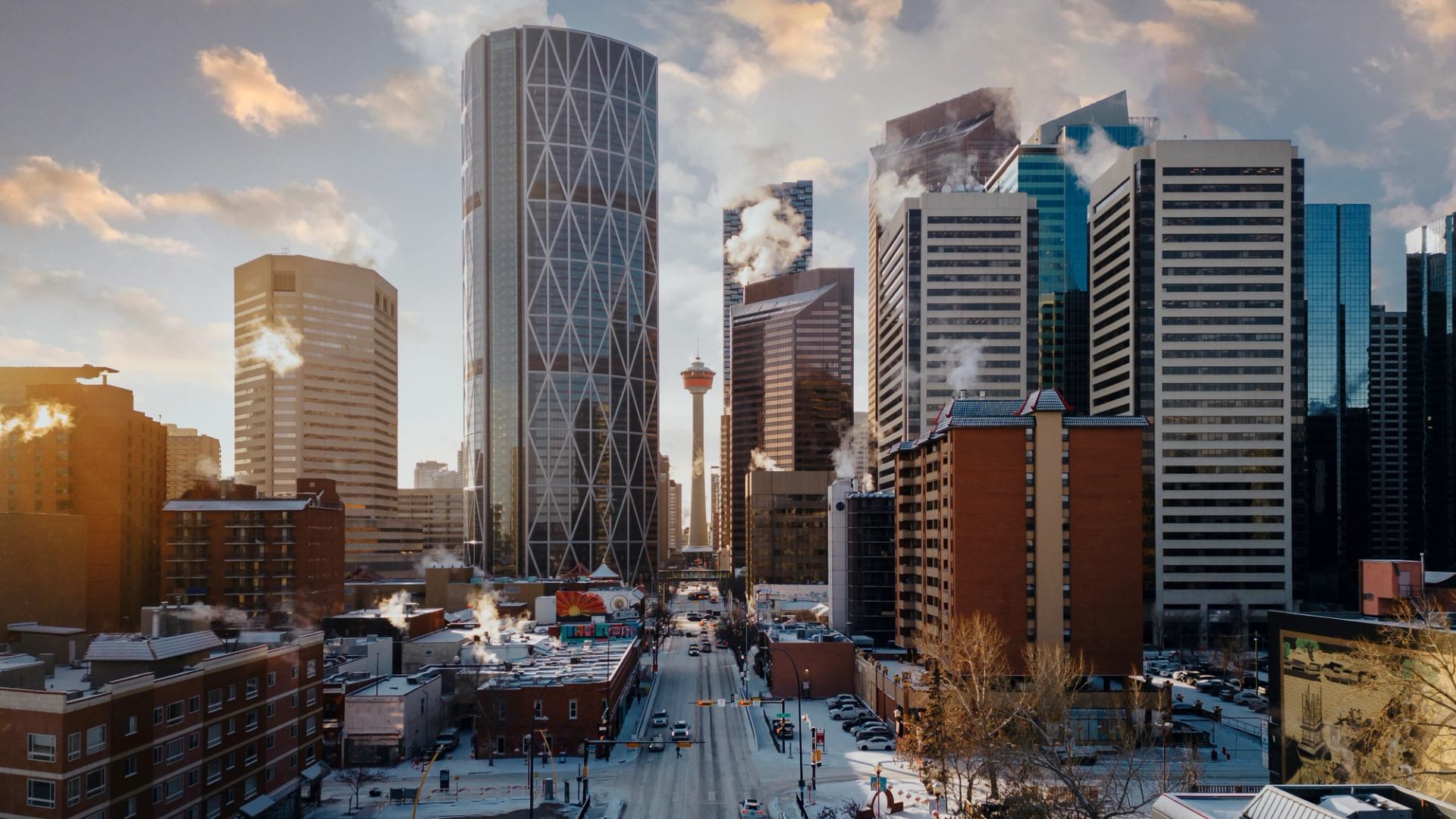 A wide view of downtown Calgary City centre with skyscrapers and the Calgary Tower on a sunny winter morning