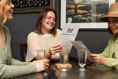 Friends look at the menu in a restaurant in Medicine Hat.