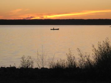 Person canoeing on Miquelon Lake, Midland Provincial Park, Alberta, Canada.