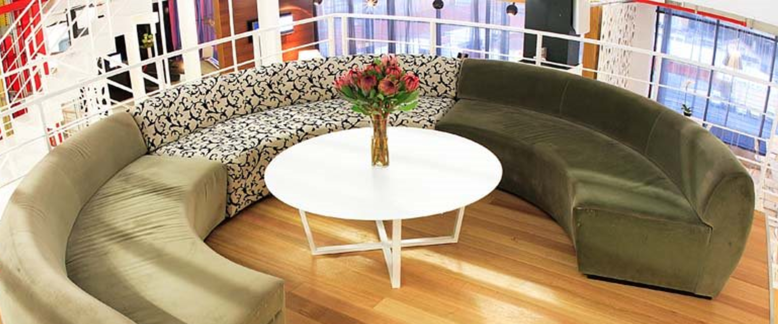 "open-plan atrium workspace with multi-level connectivity, minimalist furniture, and accent lighting"