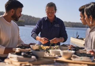 Group sharing oysters outdoors by the water, as part of The Merrimbula Merroir