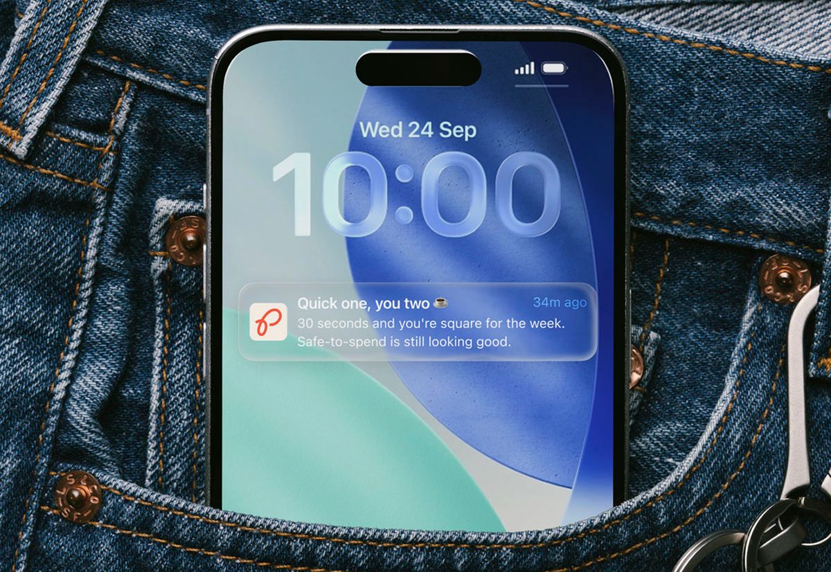 A phone in a jeans pocket, its lock screen showing a gentle nudge: “Quick one, you two — 30 seconds and you’re square for the week.”