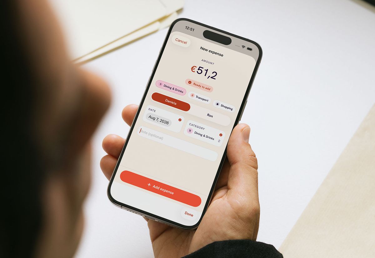 Adding an expense over someone’s shoulder: €51,2 typed in, the category and who paid already filled, and one button left to press.