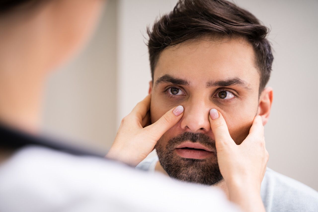 Man with irritated eyes being examined