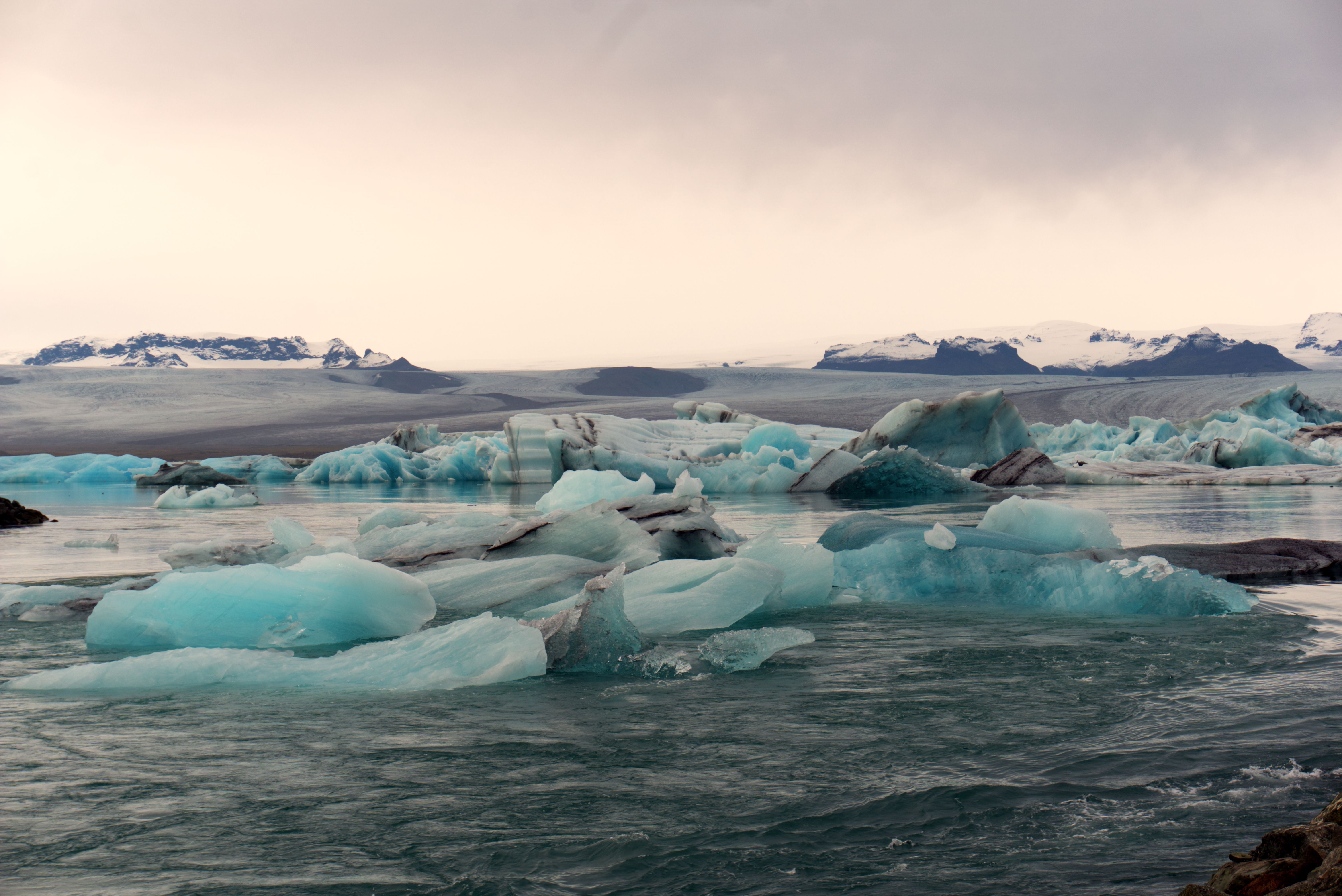Icebergs floating on Jokulsarlon glacier lagoon under a grey sky