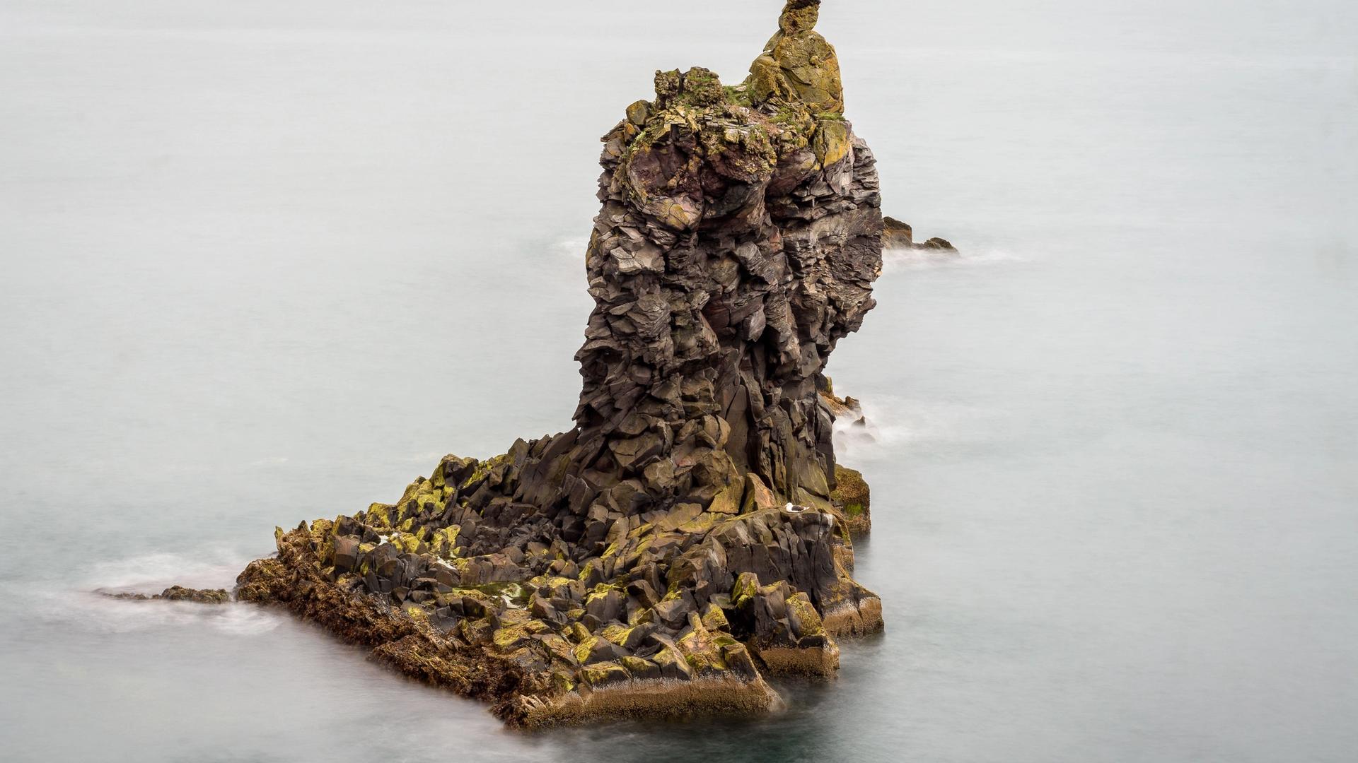 Hvitserkur basalt rock arch standing in the sea at low tide