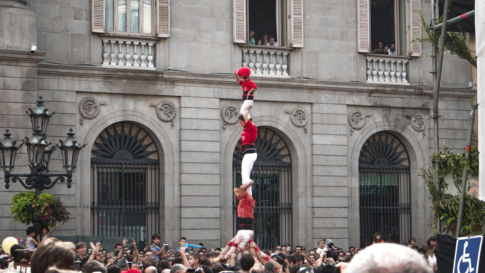 Castellers building a human tower during La Mercè festival in Barcelona