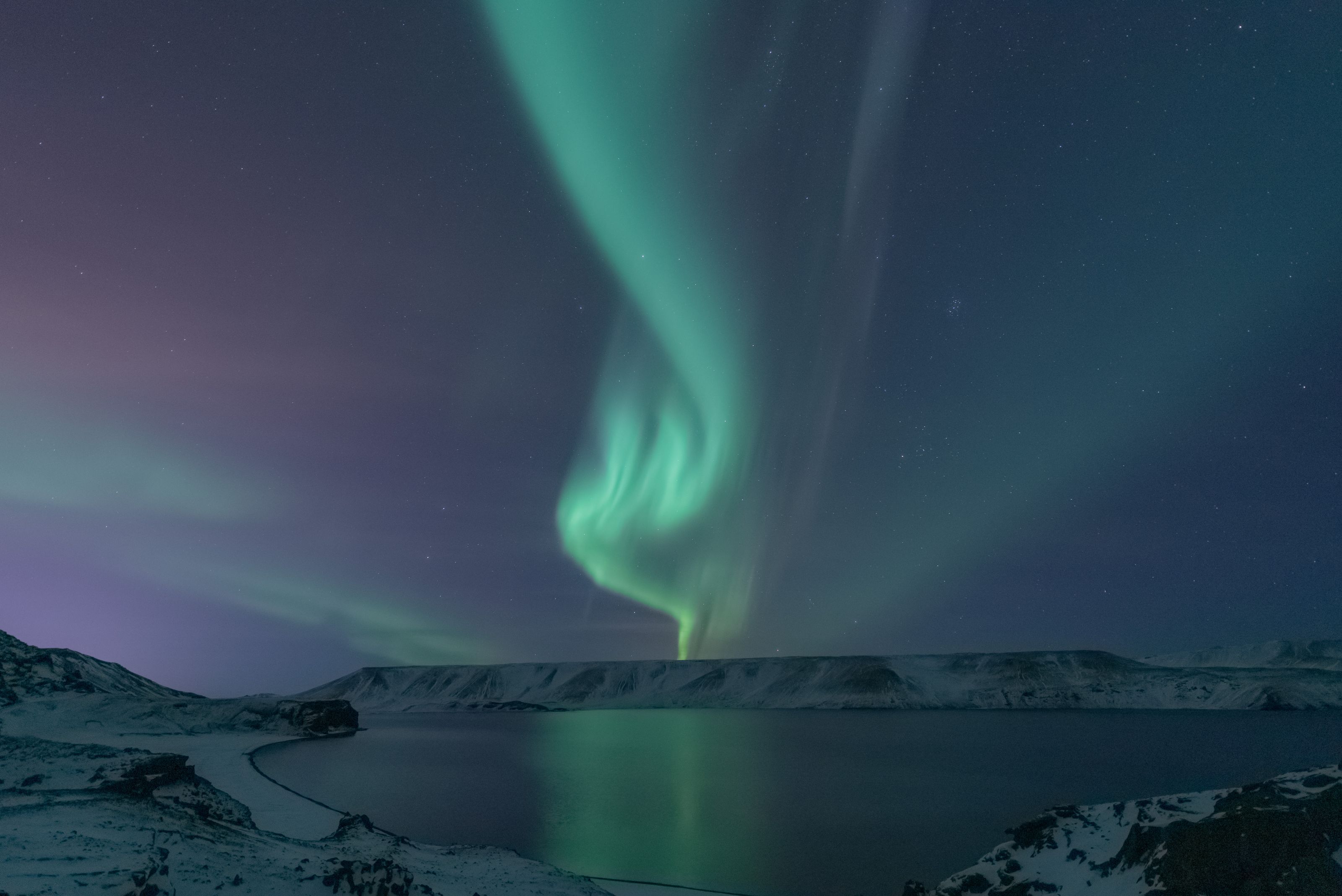 Northern lights over a snowy lake in Iceland