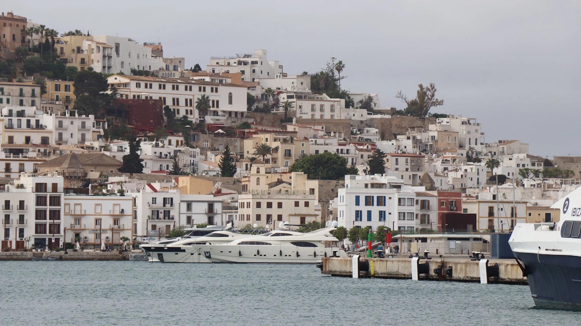 The white houses and walls of Dalt Vila rising above the harbour of Ibiza Town