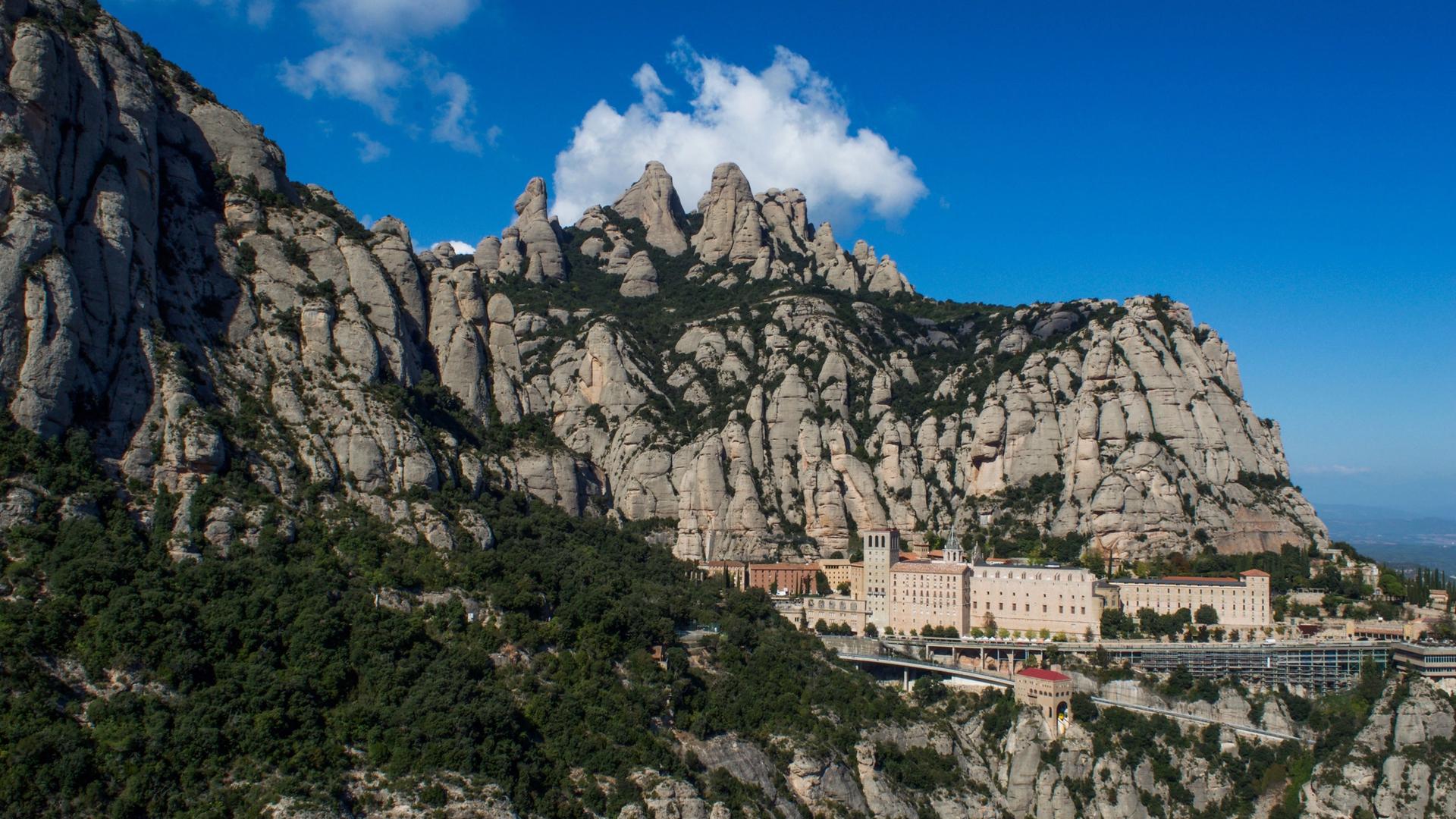 Montserrat's jagged conglomerate peaks rising above the monastery