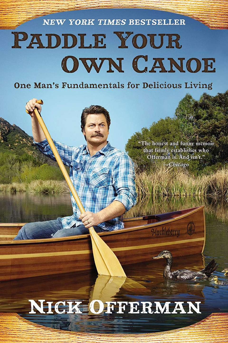 Book cover of Paddle Your Own Canoe featuring Nick Offerman paddling a wooden canoe.