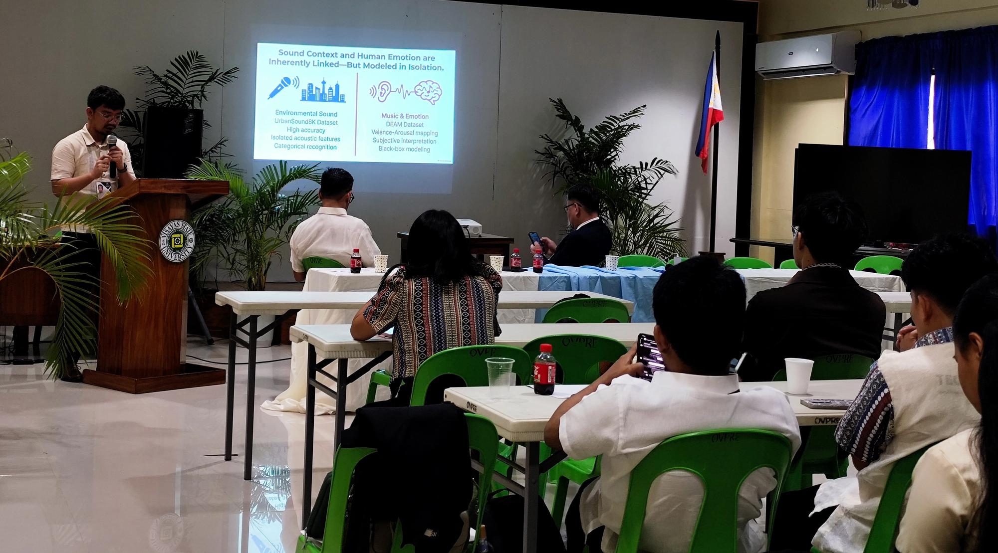 Carlo Jude P. Abuda, a faculty member of DIT-A, presents his research during the Faculty Research Presentations portion.