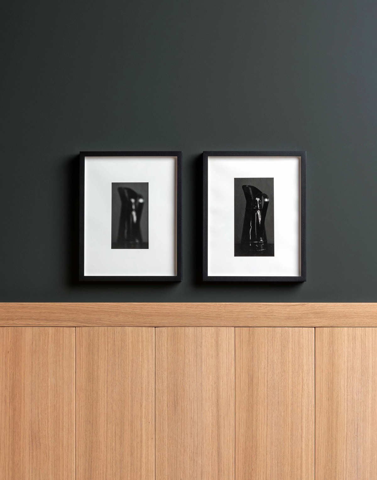Wooden high wall panels and art work on dark wall