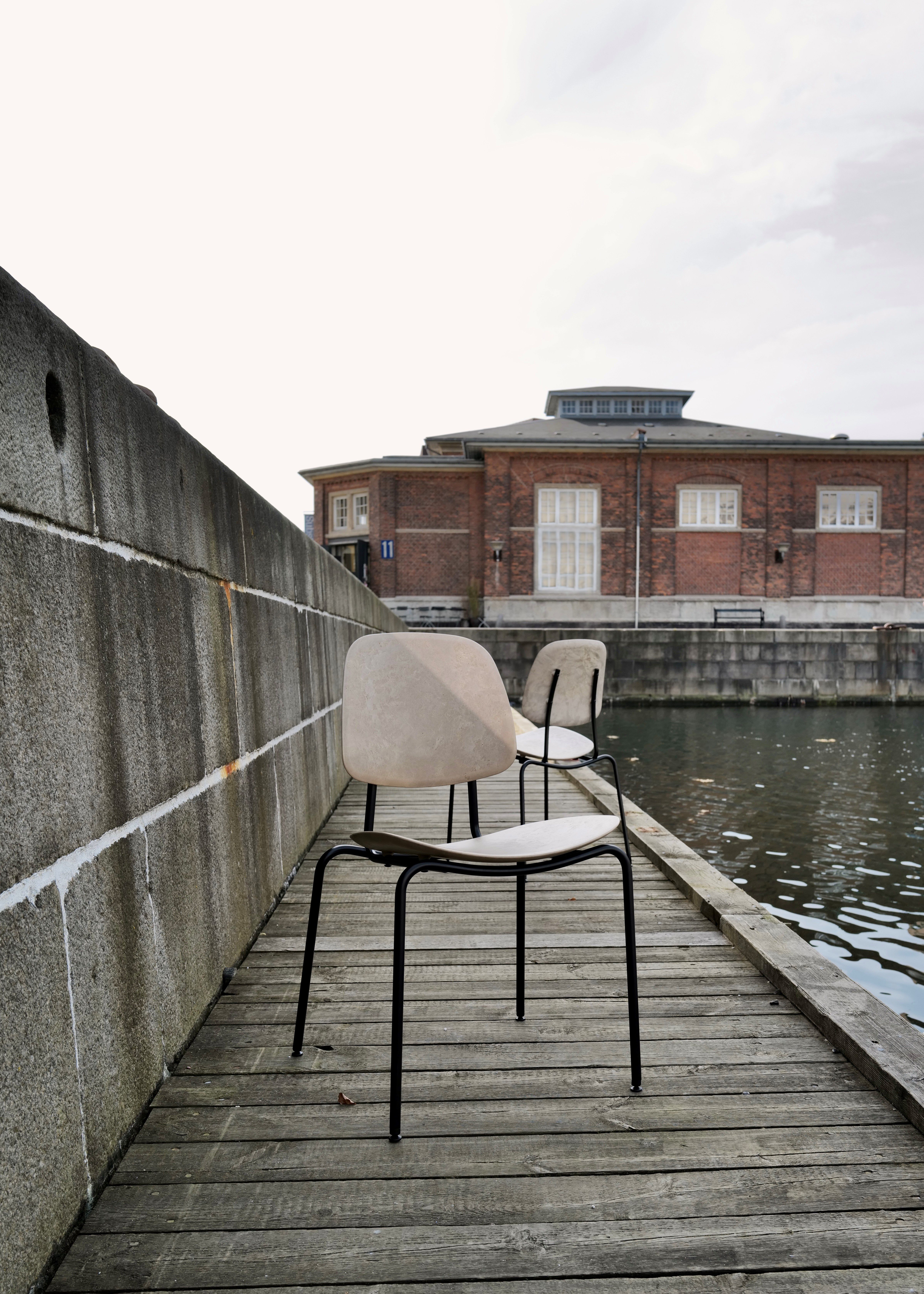 Two chairs outside in harbour setting