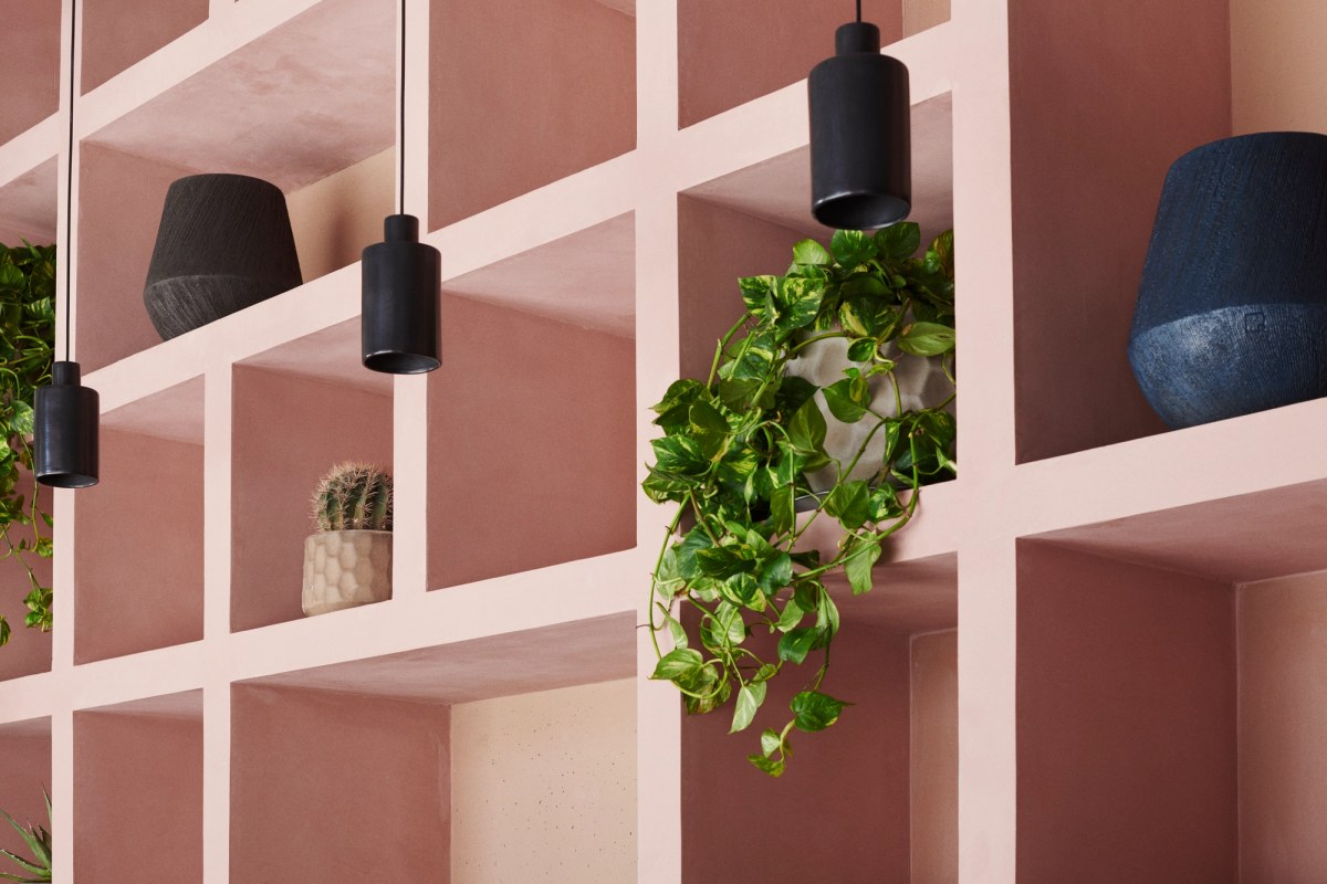 Soft pink shelves with vases and green plants